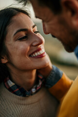 Shot of an affectionate young couple sharing a tender moment at sunset