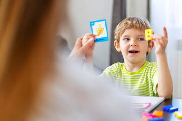 Child learning letters with flashcards