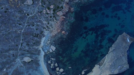 Rocky beach and sapphire sea water on the Maltese island, mediterranean sea, Ghajn Tuffieha bay , Malta. High quality photo