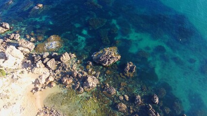 Rocky beach and sapphire sea water on the Maltese island, mediterranean sea, Ghajn Tuffieha bay , Malta. High quality photo
