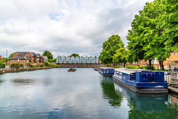 A view past pleasure boats moored in the ship canal basin in Chichester, Sussex in summertime © Nicola