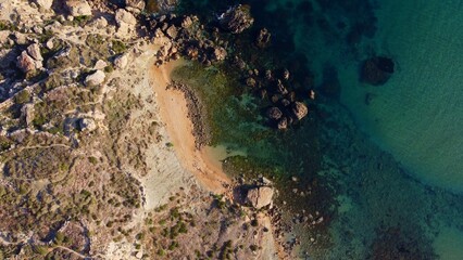 Rocky beach and sapphire sea water on the Maltese island, mediterranean sea, Ghajn Tuffieha bay ,...