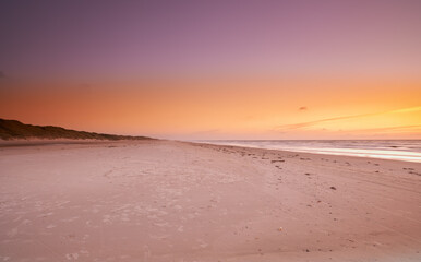 Sand, landscape or coast at sea at sunset with calm, peace or zen background for holiday, travel or vacation. Horizon, sky or view of ocean, nature or beach in Denmark for break, paradise and trip