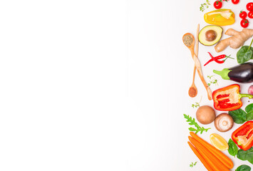 Fresh vegetables mushrooms herbs and spices ready to cook on white background with copy space.