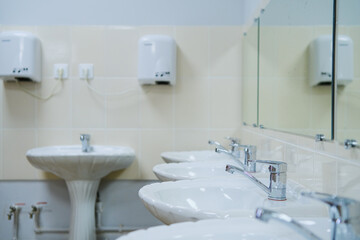 Close-up of row modern ceramic wash hand basins