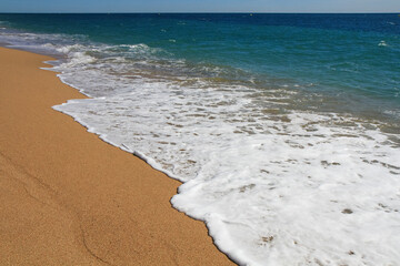beautiful landscape on the coast of the beach and sea waves against the background of the blue sky