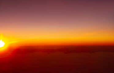 beautiful thick clouds in the sky from the height of the flight of the airplane with a view of the sunset