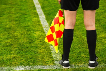 Assistant football referee and Referee's flag