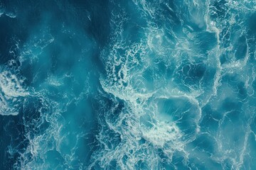 Coast with waves as a background from top view. Blue water background from drone. Summer seascape from air