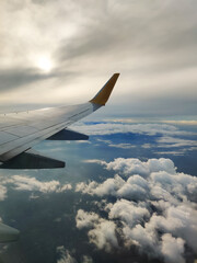 Fototapeta premium beautiful thick clouds in the sky from the height of the flight of the plane with a view of the wing with engines