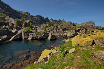 Fototapeta premium Russia. The South of Siberia. Western Sayan. Panoramic view of the alpine lake Harmony, surrounded by the harsh cliffs of the Ergaki Natural Mountain Park.