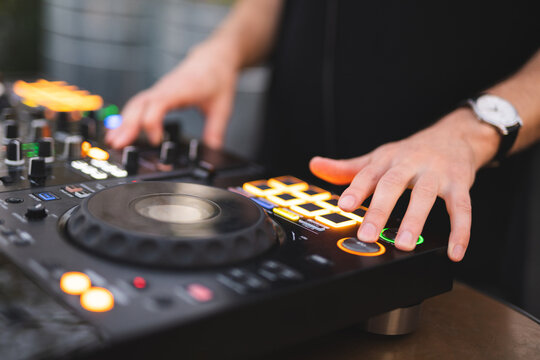 a DJ plays music on a controller at a party