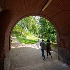couple walks in park manenburg near old city center of utrecht in the netherlands