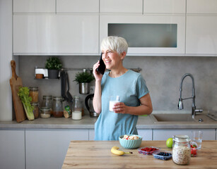 kitchen food woman healthy morning breakfast active fitness smartphone mobile phone internet phone smart phone mobile milk drink