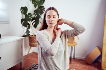 caucasian woman massaging her neck portrait, facial yoga and anti aging concept 