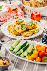 Picnic, appetizers and cheese and meat platter with sweet and savory muffins and fruits