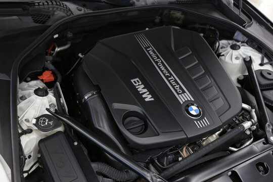Twin Power Turbo gasoline engine. BMW sport engine or motor under vehicle hood. Close up detail of new car engine. Engine motor of BMW car close-up with emblem.