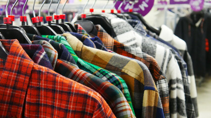Obraz premium Close-up of many colorful checkered shirts in a clothing store