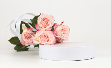 Pink rose flower bouquet and white podium. Light beige background. Minimal empty display product presentation scene.