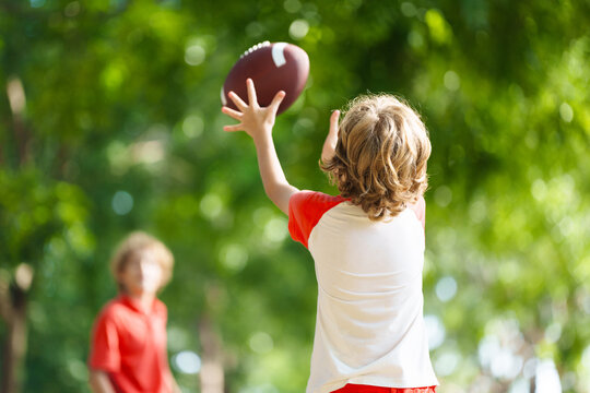 Family playing American football. Kids play rugby
