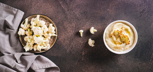 Vegetarian dietary cauliflower puree in a bowl on the table top view web banner