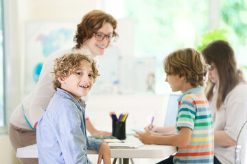 Fototapeta premium Back to school. Kids and teacher in classroom