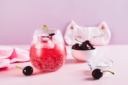 Non-alcoholic cocktail for a good sleep with cherry juice and magnesium in a glass on the table