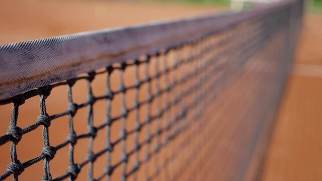 Closeup shot of a clay tennis court net, illustrating sports photography background