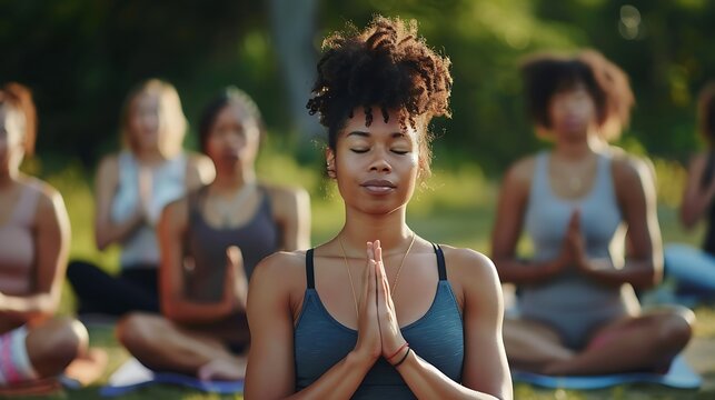 A diverse group of people practicing yoga together in a park, embracing mindfulness and wellness.