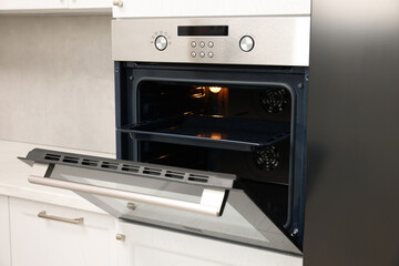 Obraz premium Open electric oven in kitchen. Cooking appliance