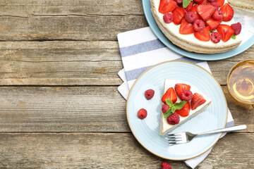 Tasty sponge cake with fresh berries served on wooden table, flat lay. Space for text