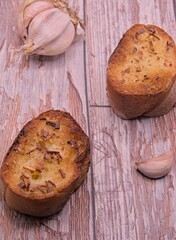 Pot of vanilla carrot crush with garlic bread on a wooden board