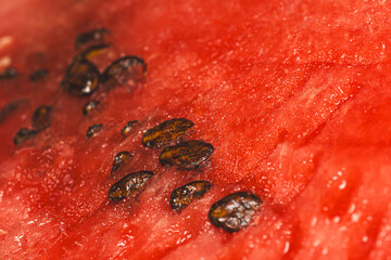Macro photography of fresh red watermelon with seeds, cut.