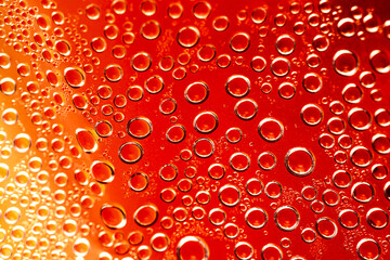 Abstract summer background with water drops on orange background.
