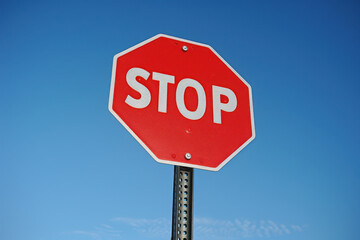 Red Stop Sign Against Clear Blue Sky