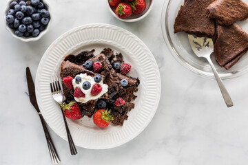 Delicious chocolate crepes topped with whip cream and berries.