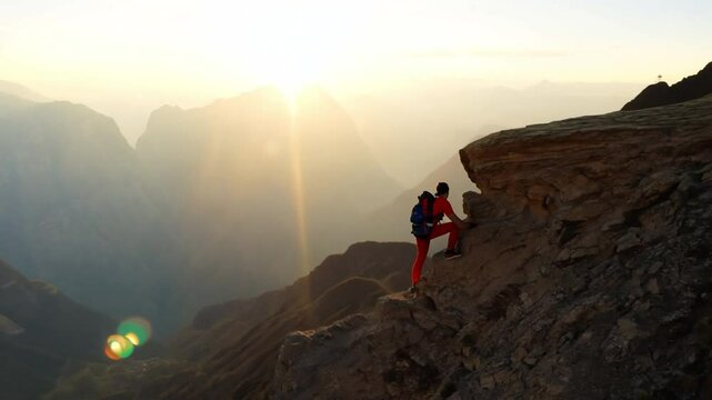 A hiker reaching the top of a mountain lending a helping hand