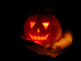 Hand with a Scary Jack-o-lantern Illuminated From Inside