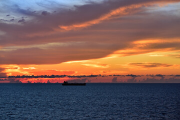Golden sunset and dramatic clouds over Atlantic Ocean