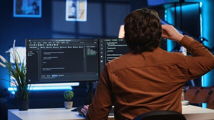 Admin using javascript coding language to fortify security and safeguard consumer data, remotely...