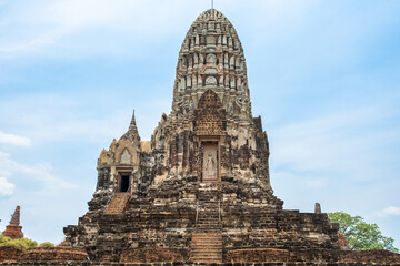 Fototapeta premium Wat Ratchaburana ancient temple in Ayutthaya historical park, Thailand, Asia. Historical Buddhist architecture on archaelogical site under blue sky. Travel and tourism destination