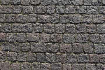 Stone road background texture. Textured background of cobblestone road. Road from brick background. Paving stone and paved road. Sidewalk background.