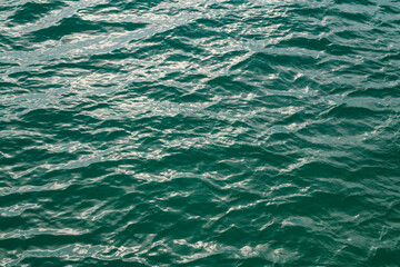 Water view. Sea water background. Green blue ocean water texture background. Sea water and ripples. Ocean background.