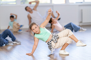 Positive girls and boys training hip hop in dance studio, dance classes for kids