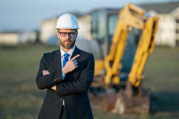 Supervisor in suit and helmet. Investor civil engineer, construction manager at a construction. Construction building developer at a construction site. Successful architect. Handsome builder man in