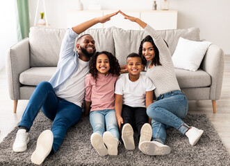 Family Care, Protection And Insurance Concept. Portrait of smiling African American parents making...