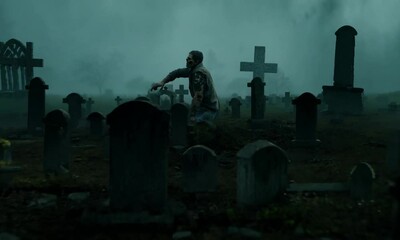 A graveyard with a creepy looking person walking through it. The atmosphere is eerie and unsettling. The person is holding a cross, which adds to the creepy vibe 4K Video