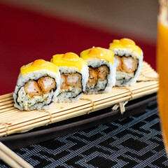 A colorful sushi platter featuring nigiri, sashimi, and maki rolls, garnished with wasabi, ginger, and soy sauce