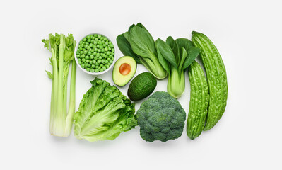 Green vegetables on a white background, modern still life, flat lay, top view