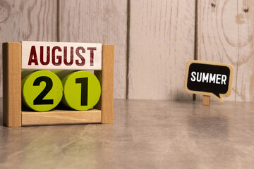 August 21 text on wooden blocks with blurred nature background. Calendar copy space.